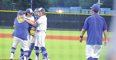 Rivercrest coach Chad Jenkins and players Mark Grider and Cayden Williams embrace Ethan Taylor after game two’s final out. Taylor racked up the complete game win as well as collected the game-winning RBIs to close out the series. TRIBUNE PHOTO / QUINTEN BOYD