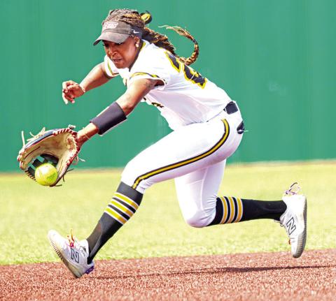Lady Tiger shortstop Azzy Fluellen backhands a ground ball during the loss to Whitehouse.