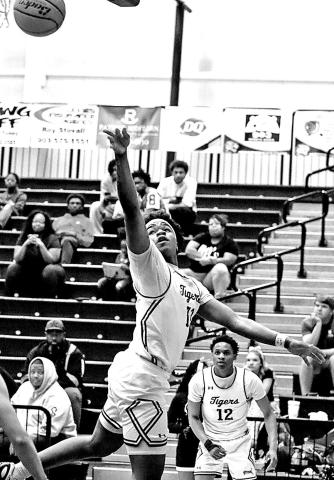 Zeke Hill floats a runner in traffic, finishing strong in the paint as Mt. Pleasant controlled the tempo against Nacogdoches.