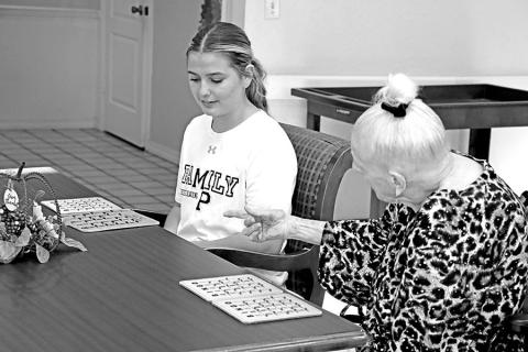 Resident Barbara Rust tells MPHS cheerleader, Adie Rosewell, to turn her card over when she wins