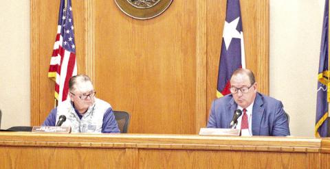 Commissioner Joe D. Mitchell (left) and Judge Kent Cooper (right) discuss property on County Road 2920.
