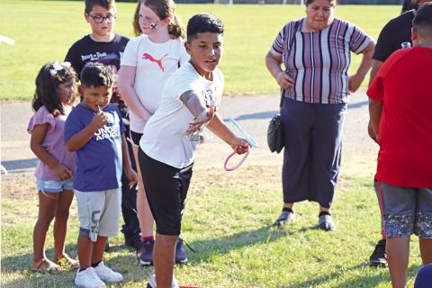 Samuel Castro plays ring toss to win a 2-liter drink COURTESY PHOTO