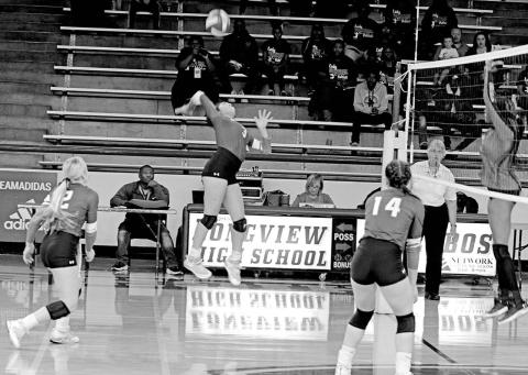 Rivercrest’s Diana Kelley jumps for a spike during Friday’s area round matchup against San Augustine as teammates Vivian Hines (left) and Kynzie Franks (right) look on. The Lady Rebels lost a tight matchup to the Lady Wolves, 3-1 (19-25, 25-22, 24-26, 26-28). TRIBUNE PHOTO / QUINTEN BOYD
