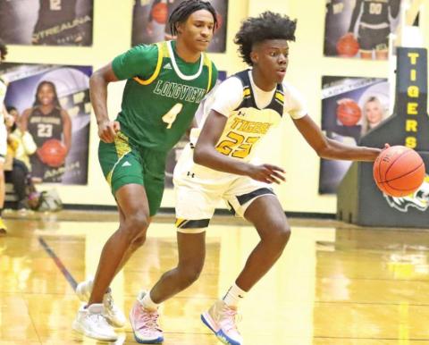 Freshman Reggie Webster drives to the basket vs Longview. PHOTO BY JOHN WHITTEN