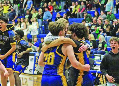 Harts Bluff head coach Bradley Lambeth embraces Kayden Mason and Cayden James as the Bulldogs celebrate their first-ever playoff win as the Bulldogs won their bi-district round matchup over Quinlan Boles in overtime, 81-78. TRIBUNE PHOTOS / QUINTEN BOYD