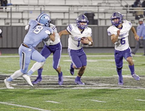 Pewitt’s Hayden Green looks for room around the outside during Friday’s bi-district game against West Rusk as JD Smith escorts him.