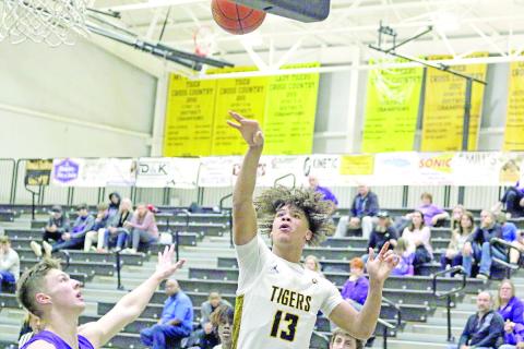 Mount Pleasant’s Kyler Smith puts up a shot during Tuesday’s home game against Hallsville. The Tigers won, 58-37.